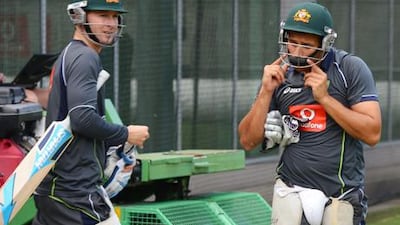 Australia captain Michael Clarke heads for training with Usman Khawaja - the batsman who will replace him if he fails to recover from injury.