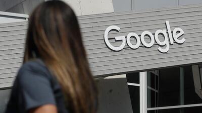 A woman walks below a Google sign on the campus in Mountain View, California, Alphabet Inc, parent company of Google reports financial earns on Monday, Oct. 28. AP Photo/Jeff Chiu