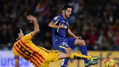 Sergio Busquets vies with Getafe midfielder Pablo Sarabia. Javier Soriano / AFP