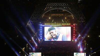 A photo shows fans watching on a giant screen the Euro 2016 football match between France and Romania on June 10, 2016 at the fan zone, near the Eiffel tower in Paris. Thomas Samson / AFP