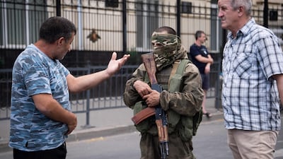 Rostov-on-Don residents speak with a Wagner fighter. AFP