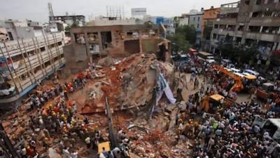 Indian rescue workers look for survivors at the site of a collapsed building in Hyderabad.