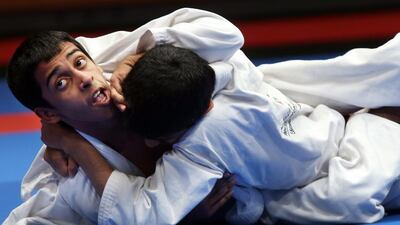Khalid Al Ali (top) grabbles with Saeed Khaled Mohammed during their match on day two of the Abu Dhabi Kids World Championship with the junior boys event on Saturday, April 16, 2016, at the IPIC Arena at Zayed Sports City in Abu Dhabi. KHalid Al Ali won the match. Delores Johnson / The National