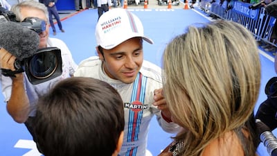 Felipe Massa, centre, celebrated his first pole since joining Williams with his son Felipinho and wife Raffaela. Mathias Kniepeiss / Getty Images