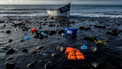 A wooden boat used by migrants from Morocco sits on the shore on the coast of the Canary Island of Gran Canaria, Spain. AP