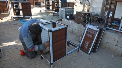 A Syrian man builds a pistachio-powered heater. AFP