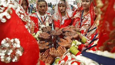 Muslim brides show hands decorated with henna paste during a mass wedding ceremony in the western Indian city of Ahmedabad on February 16, 2014. A total of 181 Muslim couples from the across the Gujarat state took part in the event organised by a Muslim voluntary organisation, organisers said. Amit Dave / Reuters