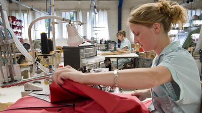 A worker sews together umbrella parts at Piganiol's facility in Aurillac. Thierry Zoccolan / AFP