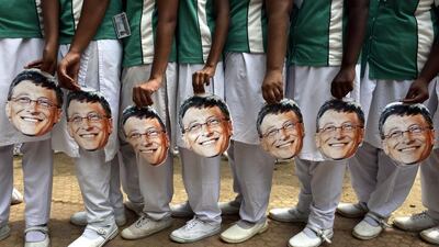 Indian schoolchildren at a school in Chennai hold masks of Microsoft founder and philanthropist Bill Gates to mark his 60th birthday,. AFP Photo