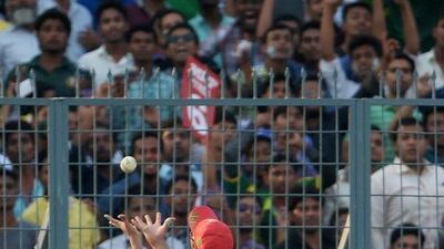 Bangladesh’s Soumya Sarkar leans across the boundary line to take a catch to dismiss Pakistan’s Mohammad Hafeez. (AFP / Dibyangshu SARKAR)