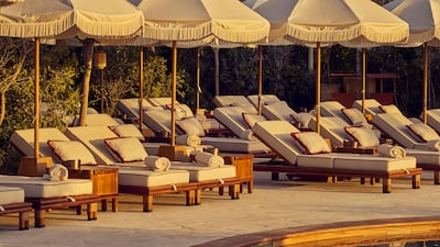 The decor at Gigi Dubai is dominated by lush foliage, a rustic palette and white parasols. Photo: Gigi Rigolatto