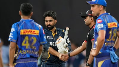 Gujarat Titans' Rahul Tewatia shakes hands with a match official after defeating Mumbai Indians. AP Photo