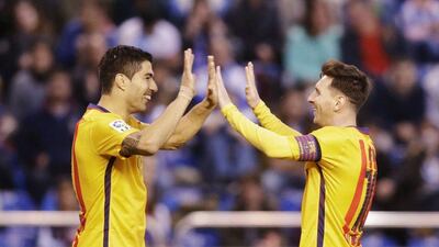 Barcelona’s Lionel Messi, right, celebrates his goal against Deportivo with teammate Luis Suarez. Miguel Vidal / Reuters