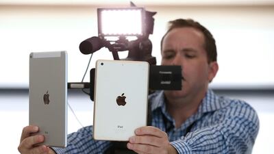 A member of the media films the new iPad Air 2, left, and iPad Mini 3 during an Apple special event on October 16, 2014 in Cupertino, California. Justin Sullivan /Getty Images / AFP