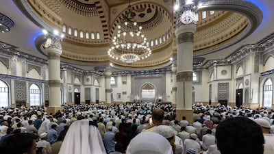 Worshippers perform Eid Al Adha morning prayers at Al Farooq Omar bin Al Khattab Mosque in Dubai. Antonie Robertson / The National