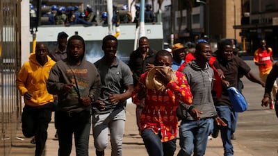 Protesters flee from teargas during clashes with the police in Harare, Zimbabwe. Reuters