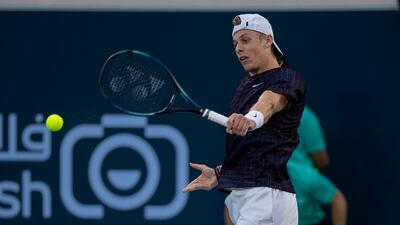 Denis Shapovalov hits a backhand to Andrey Rublev at the Mubadala World Tennis Championship. Victor Besa / The National