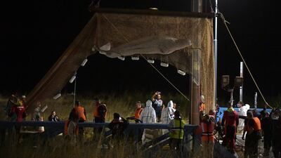 The whale was lifted from the river by a net and crane on Wednesday morning and placed on a barge. AFP