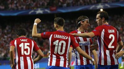 Atletico’s Yannick Carrasco celebrates with teammates after scoring the opening goal against Bayern Munich. Daniel Ochoa de Olza / AP Photo