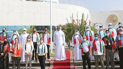 Sheikh Mohammed bin Sultan bin Khalifa raises the flag. WAM