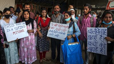 People hold placards as they protest over a gang-rape case in Mumbai, India, in September 2021. All photos: EPA