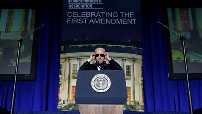 US President Joe Biden puts on sunglasses after making a joke about becoming the 'Dark Brandon' persona during the White House Correspondents' dinner in Washington. AP
