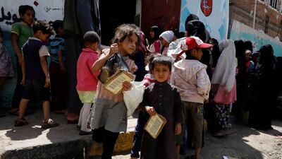 Yemeni children gather to get free food rations from a charity group in Sanaa, Yemen. EPA