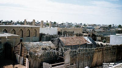A view of Abu Dhabi showing the various architectural styles including barasti, coral stone and brick dwellings. Photo: Dr Alan Horan © UAE National Library and Archives