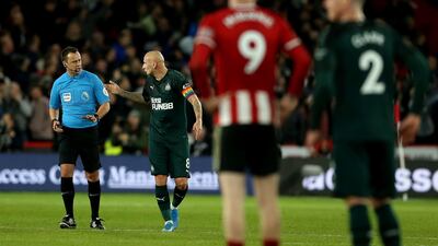 Jonjo Shelvey of Newcastle asks referee Stuart Attwell to check with VAR. Getty