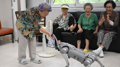 Elderly participants interact with a robot dog during a government-organised digital survival training session at a senior community centre in Suwon, South Korea. AFP