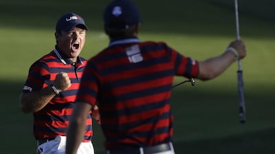 United States’Patrick Reed reacts with teammate Jordan Spieth as he makes his putt to win the match on the 15th hole. Chris Carlson / AP Photo