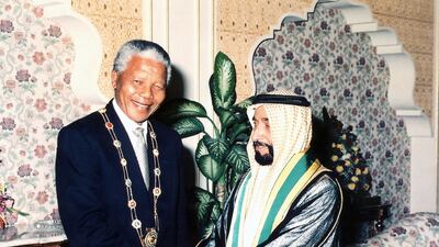 Sheikh Zayed awards the "Order of Zayed" to South African president Nelson Mandela on the 1995 visit to the UAE. Courtesy National Archives