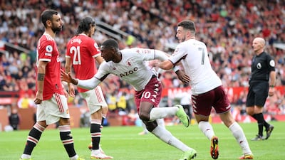 Villa's Kortney Hause celebrates with teammate John McGinn after scoring the winning goal. Getty