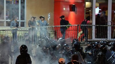 Riot police and military police fire tear gas during a protest of supporters of the Libertad y Refundacion (LIBRE) opposition party against Honduran President Juan Orlando Hernandez in Tegucigalpa. AFP