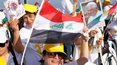 Christians hold up Iraqi and Kurdish national flags, along with Pope Benedict XVI pictures, upon his arrival in Beirut to conduct an open-air Mass.