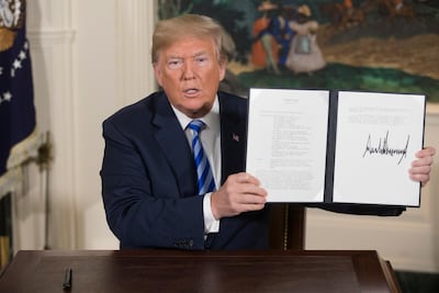 US President Donald Trump holds up a presidential memorandum on May 8, 2018 announcing plans to pull out of Iran nuclear deal. EPA