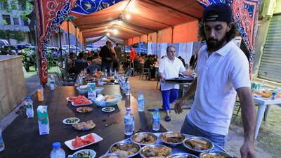A Libyan lays out dishes on a tray to be served for iftar in Benghazi. AFP