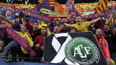 FC Barcelona fans cheer for their team and hold a sign honouring Chapecoense prior to the clasico at the Camp Nou last weekend. Alberto Estevez / EPA / December 3, 2016