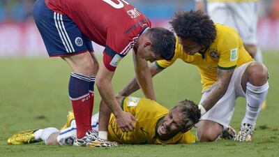 Brazil's Neymar screams out after being fouled during the World Cup quarterfinal soccer match between Brazil and Colombia at the Arena Castelao in Fortaleza, Brazil, Friday, July 4, 2014. The injured star will be with his team during Saturday's third place play-off against the Netherlands. AP Photo/Manu Fernandez