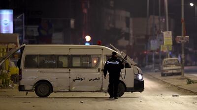 Tunisian security forces chase protesters. Fethi Belaid / AFP Photo