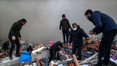 Rescuers search for survivors at the site of a collapsed building in Iskenderun. EPA