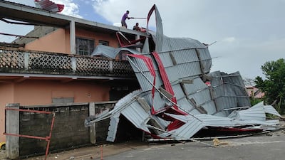 People work on a damaged building in Mananjary district, Madagascar after Cyclone Freddy pummelled the island nation. AP