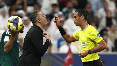 Palestine coach Ehab Abu Jazar implores to referee Amin Mohamed Omar. Reuters