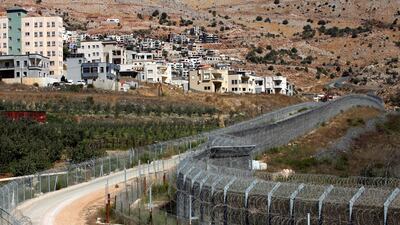 A picture from September 7, 2014 shows the village of Majdal Shams (L) in the Occupied Golan Heights which overlooks Israel's controversial separation barrier. AFP Photo