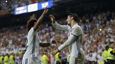 Real Madrid forward Alvaro Morata, right, celebrates with Marcelo after scoring the opening goal against Celta Vigo. Francisco Seco / AP Photo