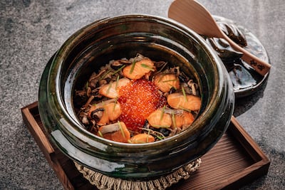 The ninth course, oshokuji, is a warm, deeply comforting bowl of slow-cooked rice and rare keiji salmon with wild mushroom, topped with caviar pearls. Photo: Kigo