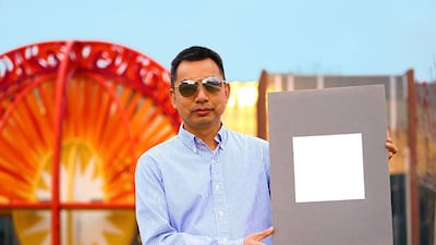 Xiulin Ruan, a Purdue University professor of mechanical engineering, holds up his lab’s sample of the whitest paint on record. Purdue University/Jared Pike