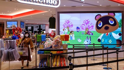 A screen showing the characters from the widely popular Animal Crossing series video game is seen at a Nintendo store in Tokyo. AFP