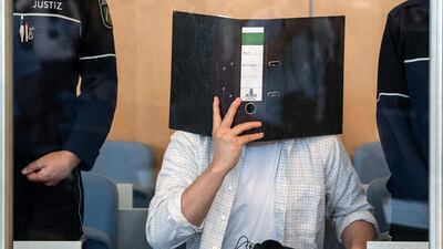Defendant Sief Allah H. holds a folder in front of his face during his trial for planning a foiled biological bomb attack with the deadly poison ricin. AFP / dpa / Federico Gambarini