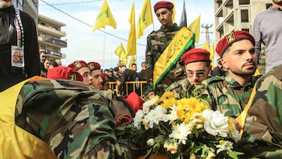 Members of Lebanon's Shiite militant group Hezbollah mourn over the coffins of comrades killed in recent Israeli attacks during their funeral in the southern city of Nabatiyeh. AFP